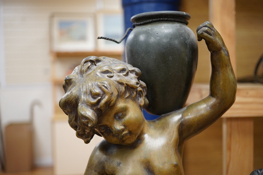 After Auguste Moreau, a 19th century French bronzed spelter figure of an amorini carrying a water pitcher, ‘’Le Ruisseau’’, and another of Venus de Milo (2). Condition - fair to good